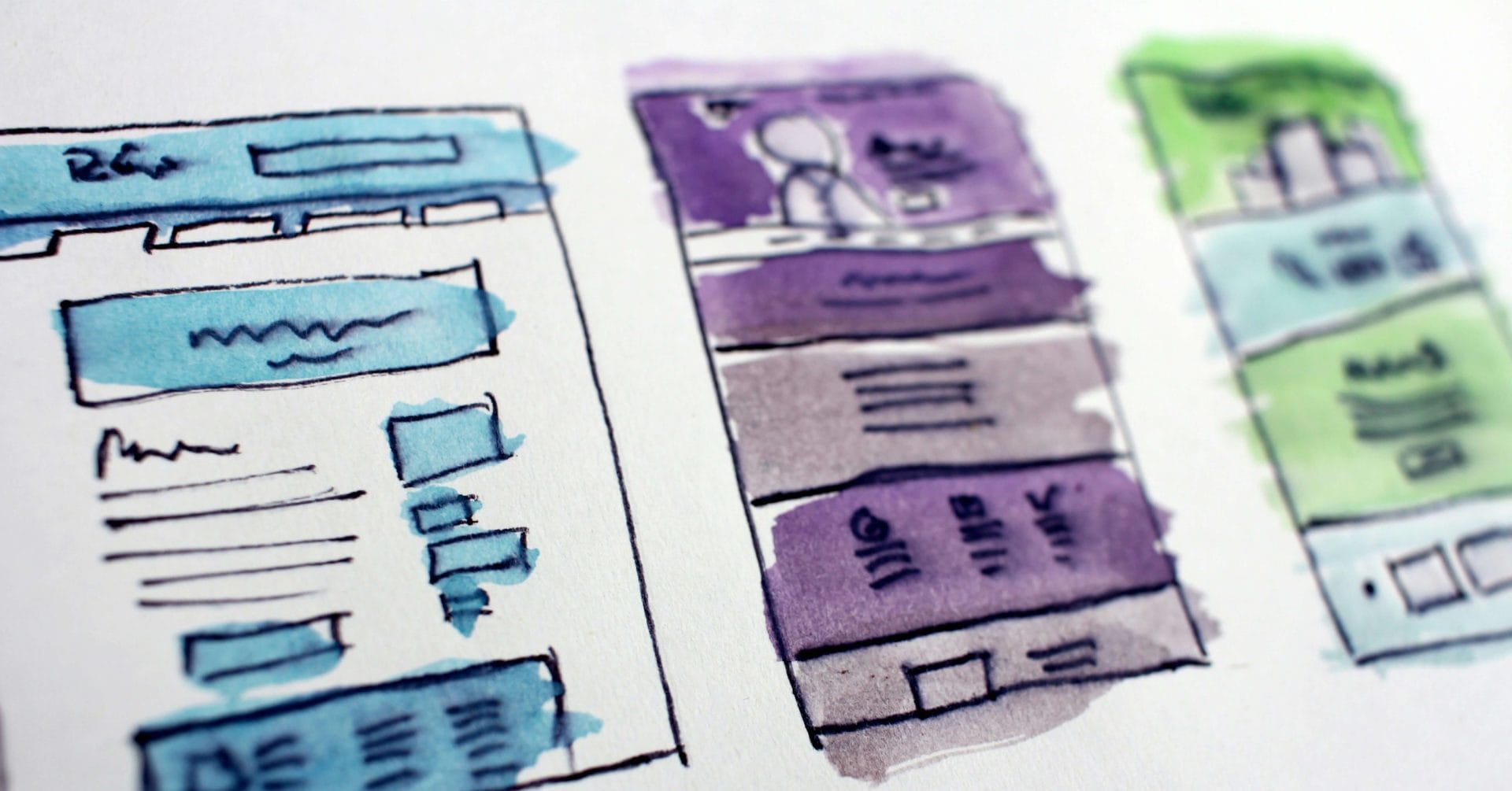 Three colorful, hand-drawn website wireframes with blue, purple, and green accents.