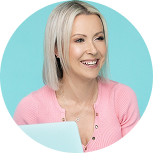 Smiling woman with blonde hair in a pink top represents a b2b marketing agency.